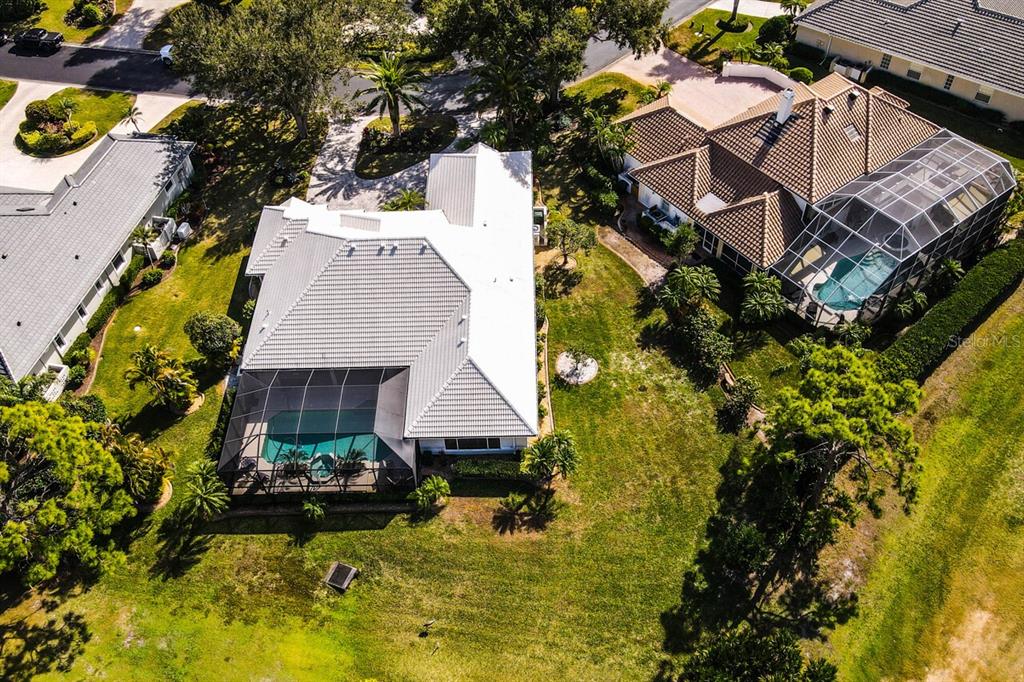 429 Tremingham Way Venice, FL 34293 - Photo 57 of 73 a aerial view of a house with swimming pool and large trees