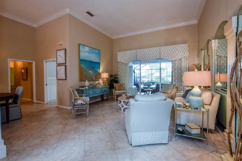 429 Tremingham Way Venice, FL 34293 - Photo 6 of 73 a living room with furniture and a dining table