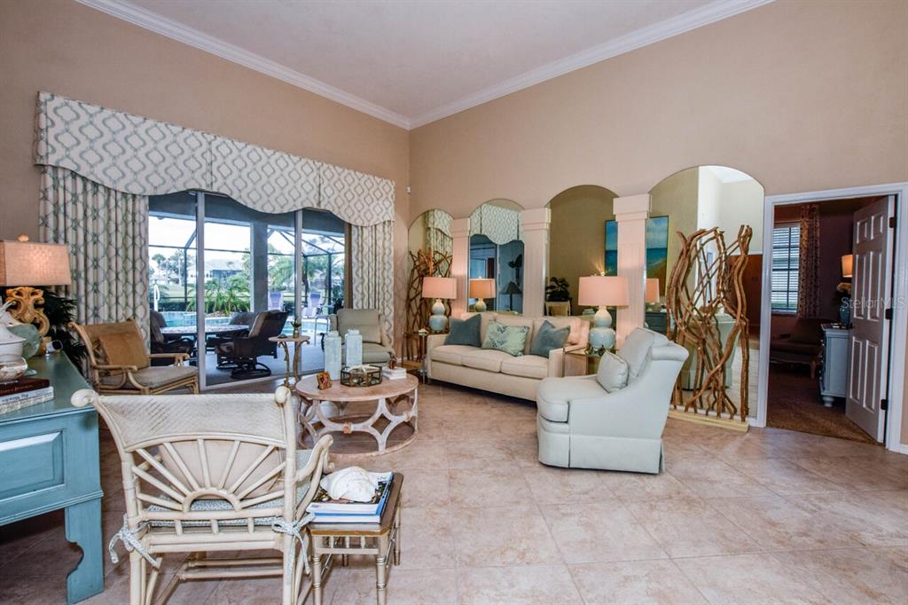 429 Tremingham Way Venice, FL 34293 - Photo 7 of 73 a living room with fireplace furniture and a large window