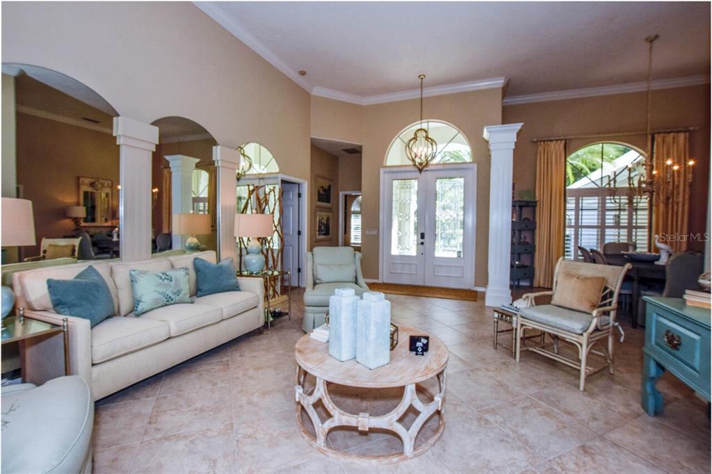 429 Tremingham Way Venice, FL 34293 - Photo 8 of 73 a living room with furniture chandelier and a large window
