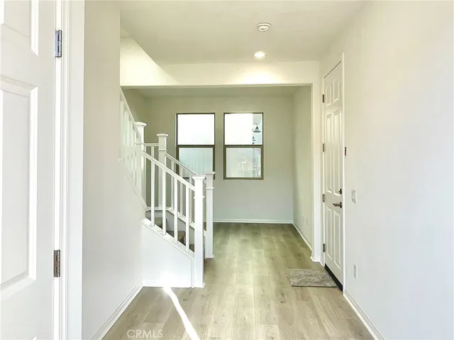 a view of an entryway with wooden floor