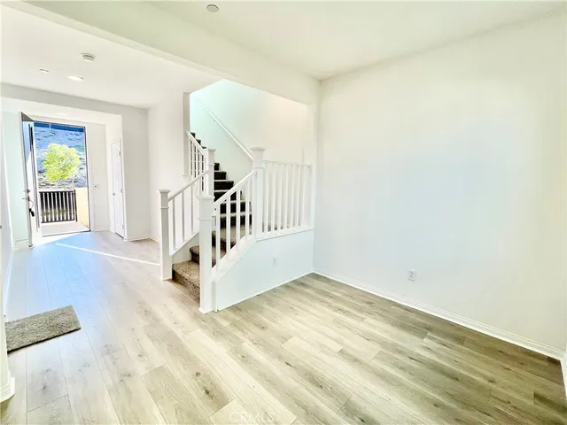 a view of an entryway with wooden floor