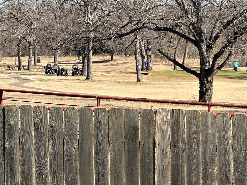 2020 Arbor Bend Road Bonham, TX 75418 - Photo 7 of 7 a view of a yard with wooden fence and a large tree
