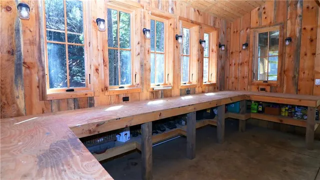 a room with lots of wooden furniture wooden floor and windows