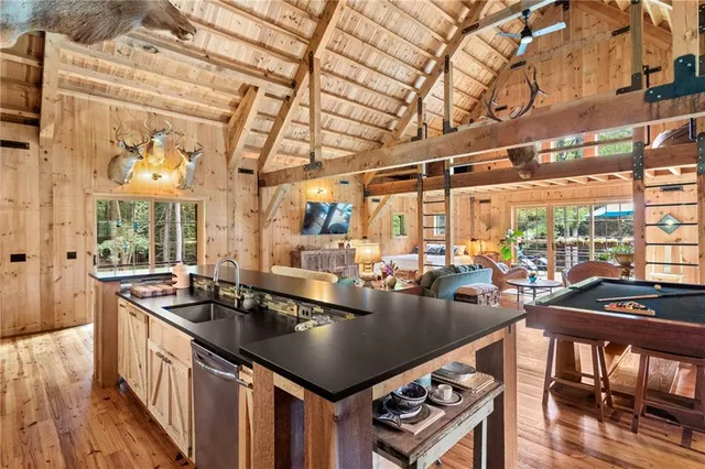 a kitchen with a stove a sink and cabinets