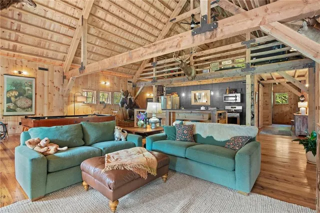 a living room with furniture and a chandelier
