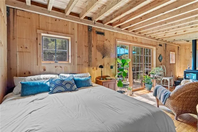 a bedroom with furniture and large windows