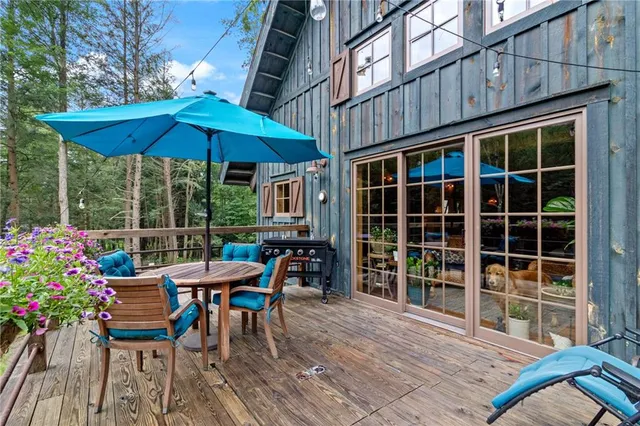 an outdoor sitting area with furniture and wooden deck