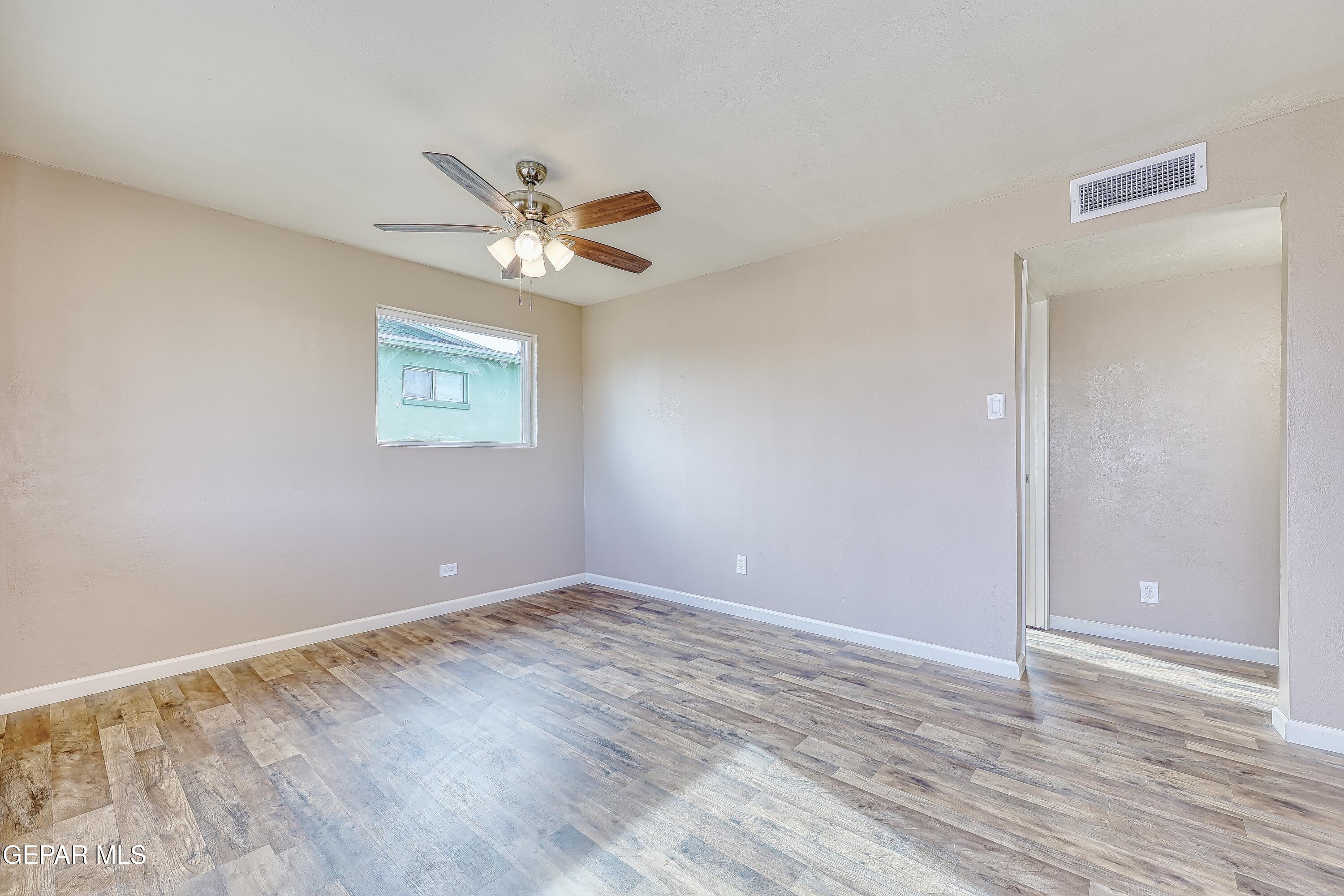 7212 Raton Drive El Paso, TX 79915 - Photo 11 of 44 a view of an empty room with a window and a ceiling fan
