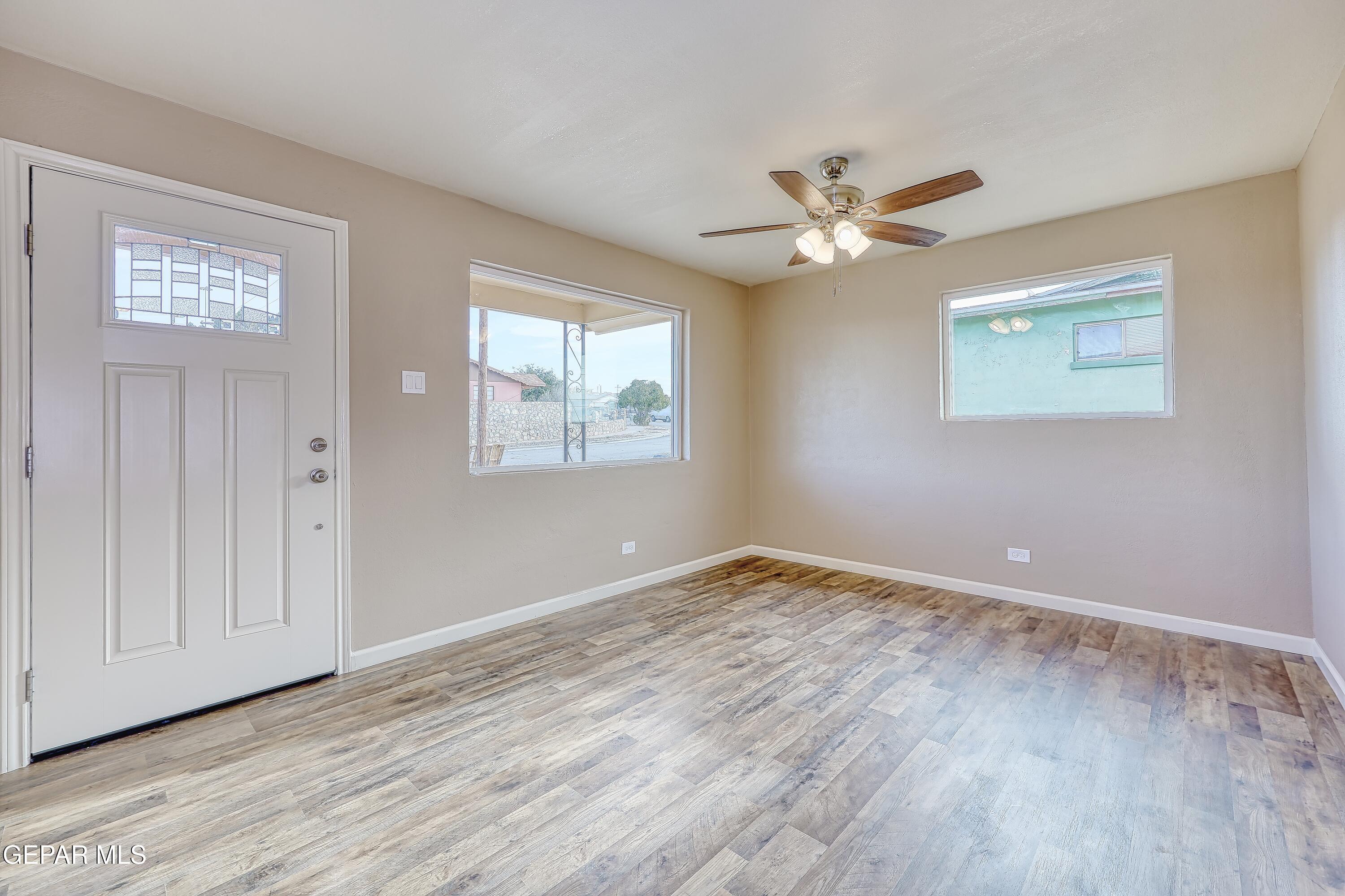 7212 Raton Drive El Paso, TX 79915 - Photo 13 of 44 a view of an empty room with a window and wooden floor