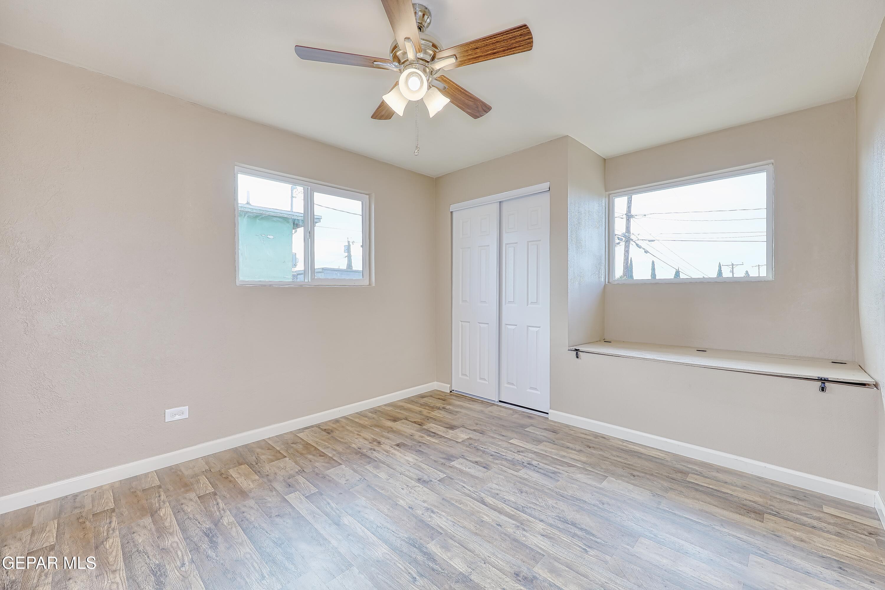 7212 Raton Drive El Paso, TX 79915 - Photo 15 of 44 wooden floor in an empty room with a window