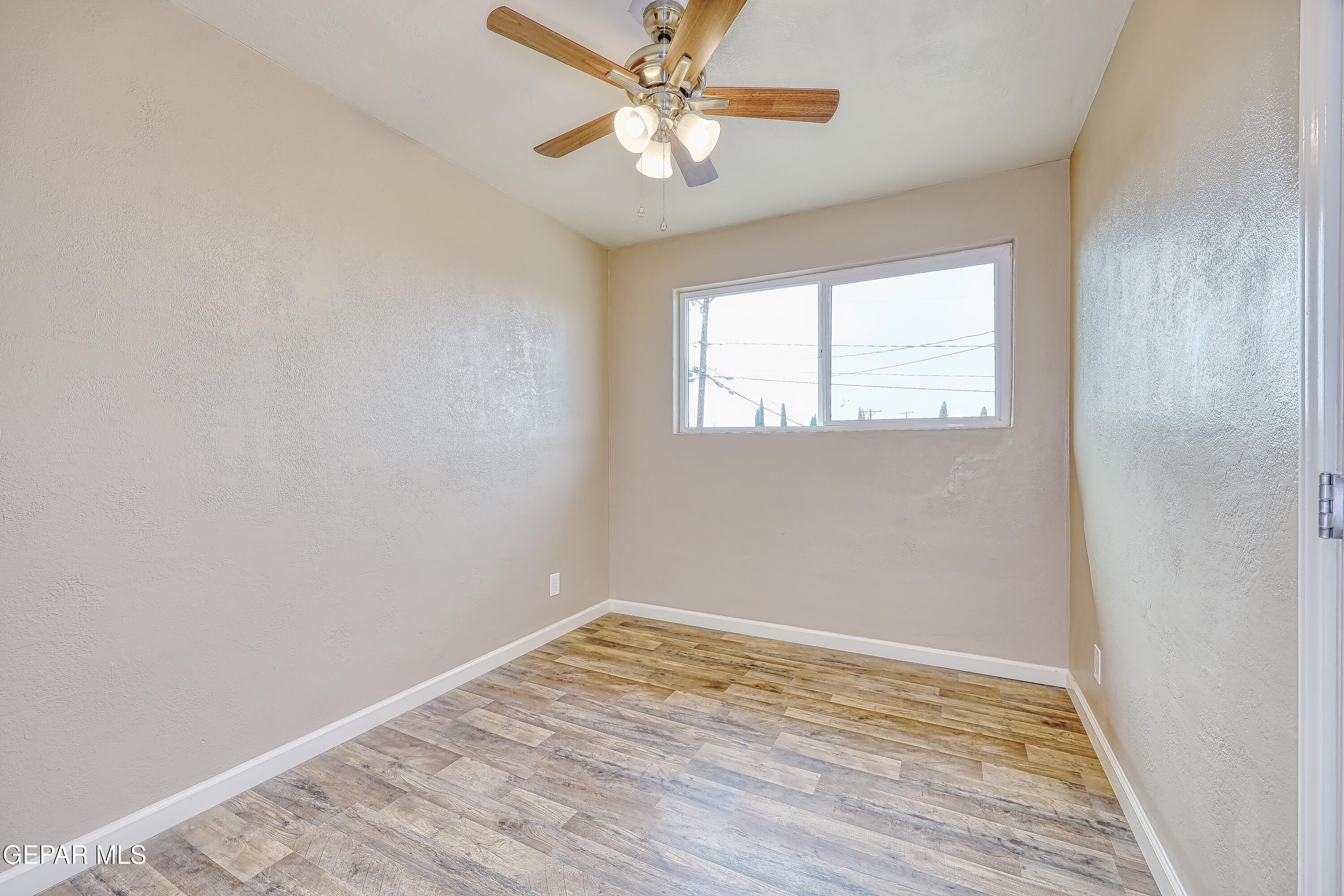 7212 Raton Drive El Paso, TX 79915 - Photo 17 of 44 an empty room with a window and wooden floor