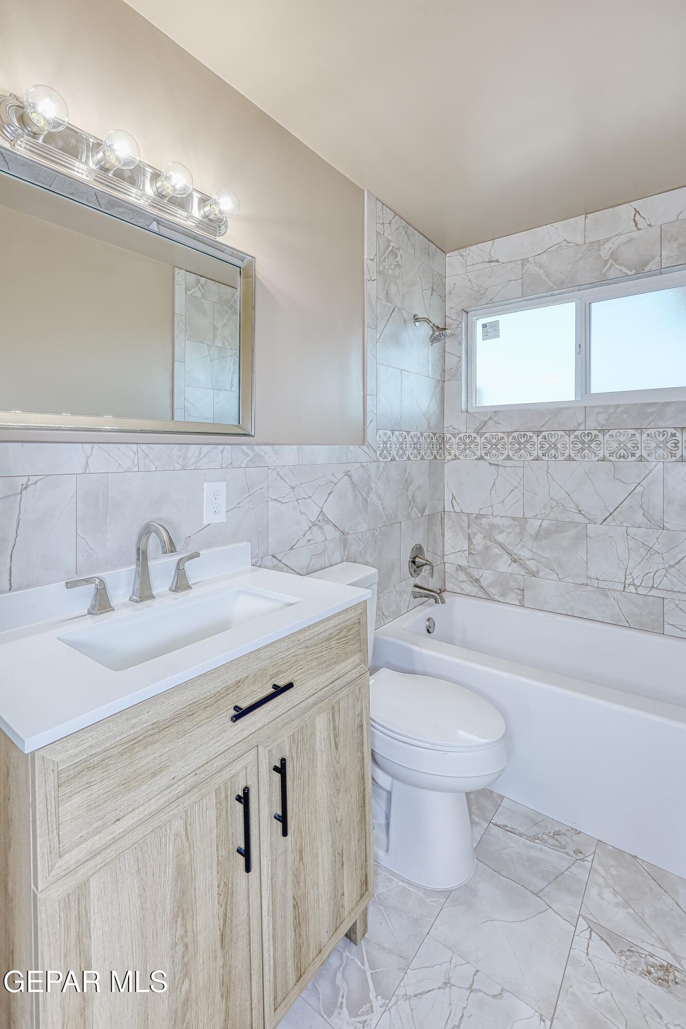 7212 Raton Drive El Paso, TX 79915 - Photo 20 of 44 a bathroom with a granite countertop sink a toilet a mirror and bathtub