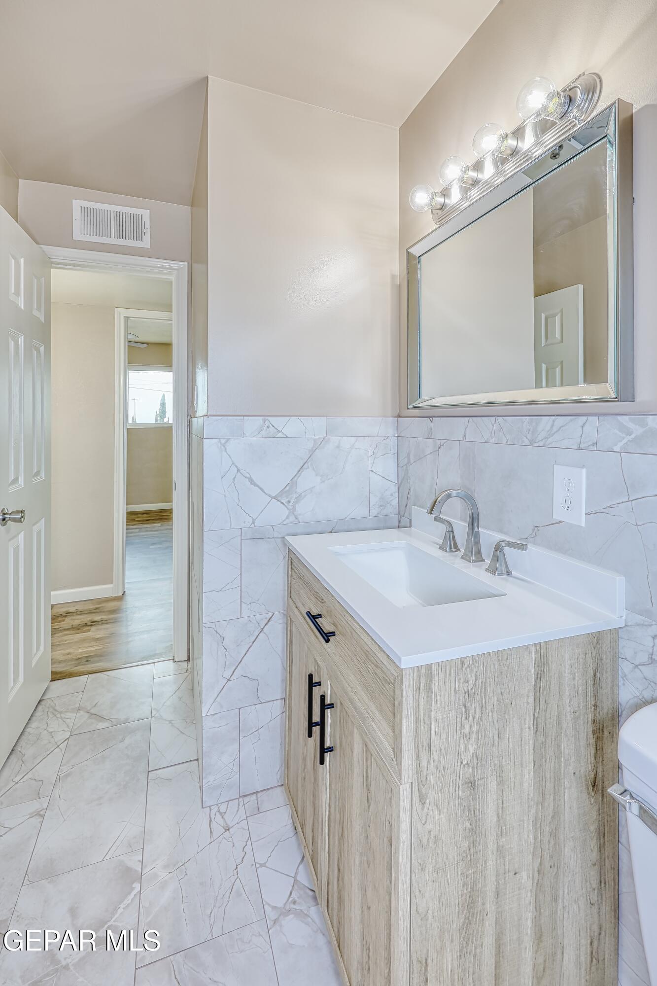 7212 Raton Drive El Paso, TX 79915 - Photo 21 of 44 a bathroom with a sink a vanity and a mirror