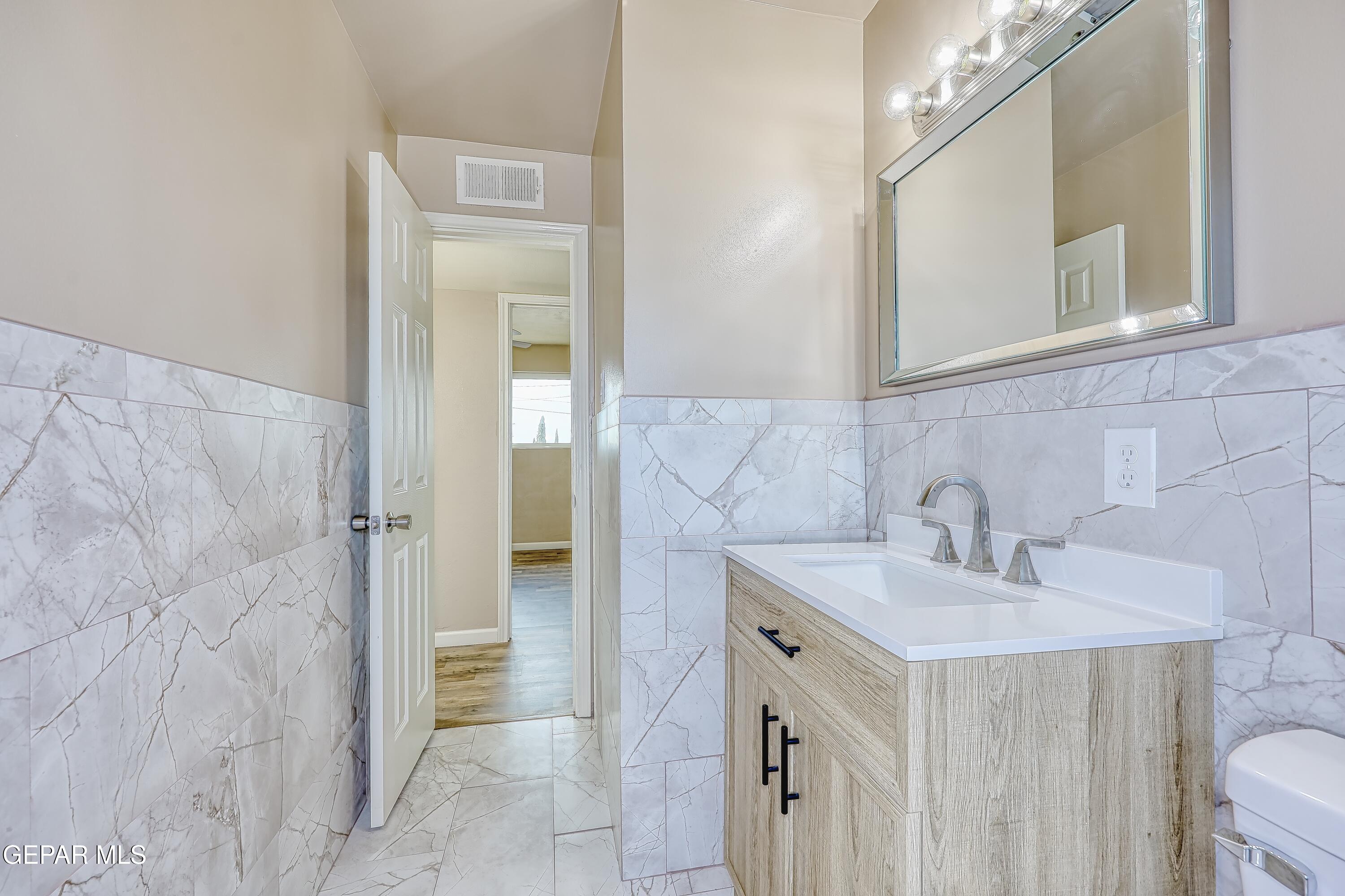 7212 Raton Drive El Paso, TX 79915 - Photo 22 of 44 a bathroom with a sink and a mirror