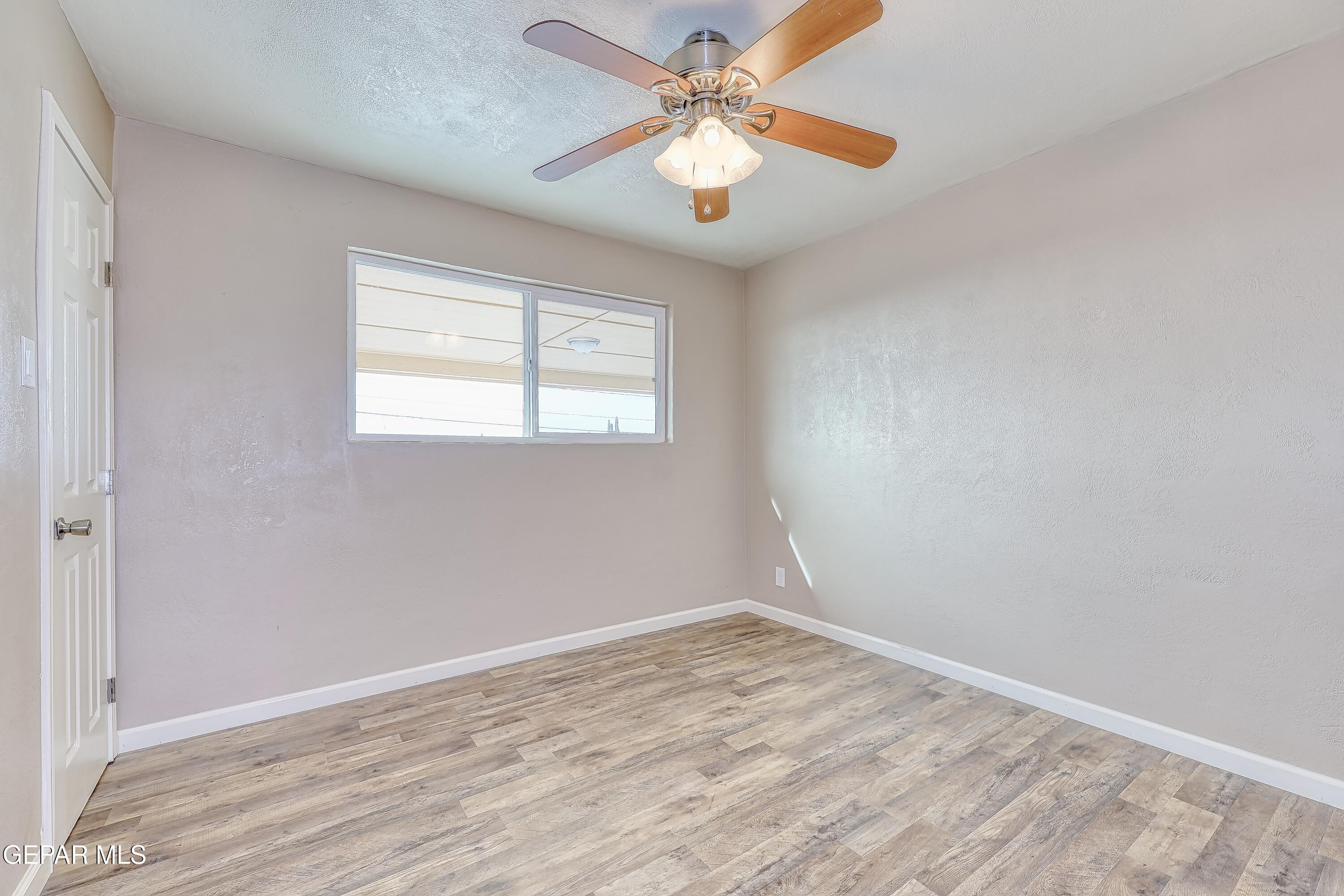 7212 Raton Drive El Paso, TX 79915 - Photo 23 of 44 an empty room with a window and a fan