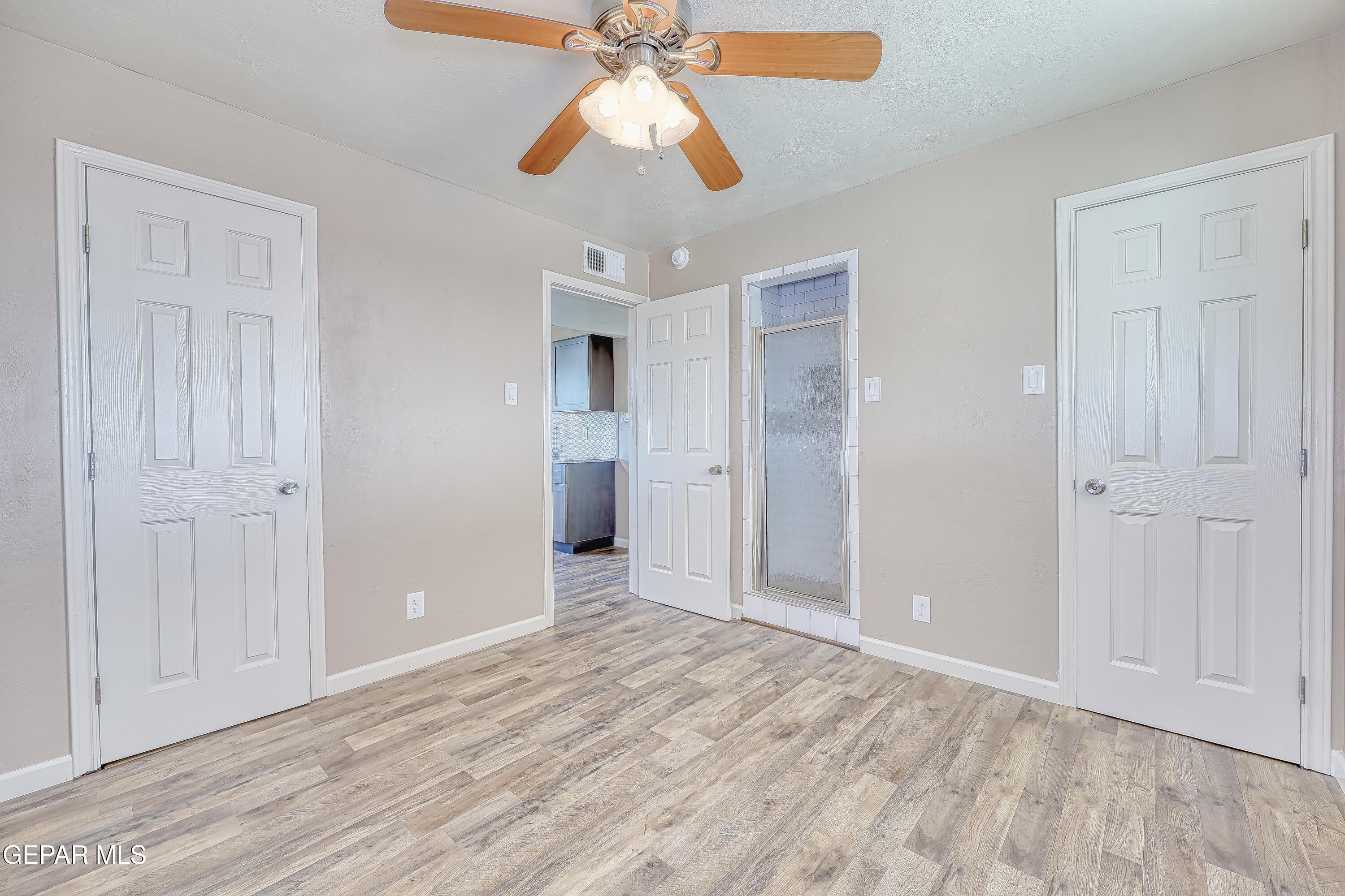7212 Raton Drive El Paso, TX 79915 - Photo 24 of 44 wooden floor in an empty room with a chandelier fan