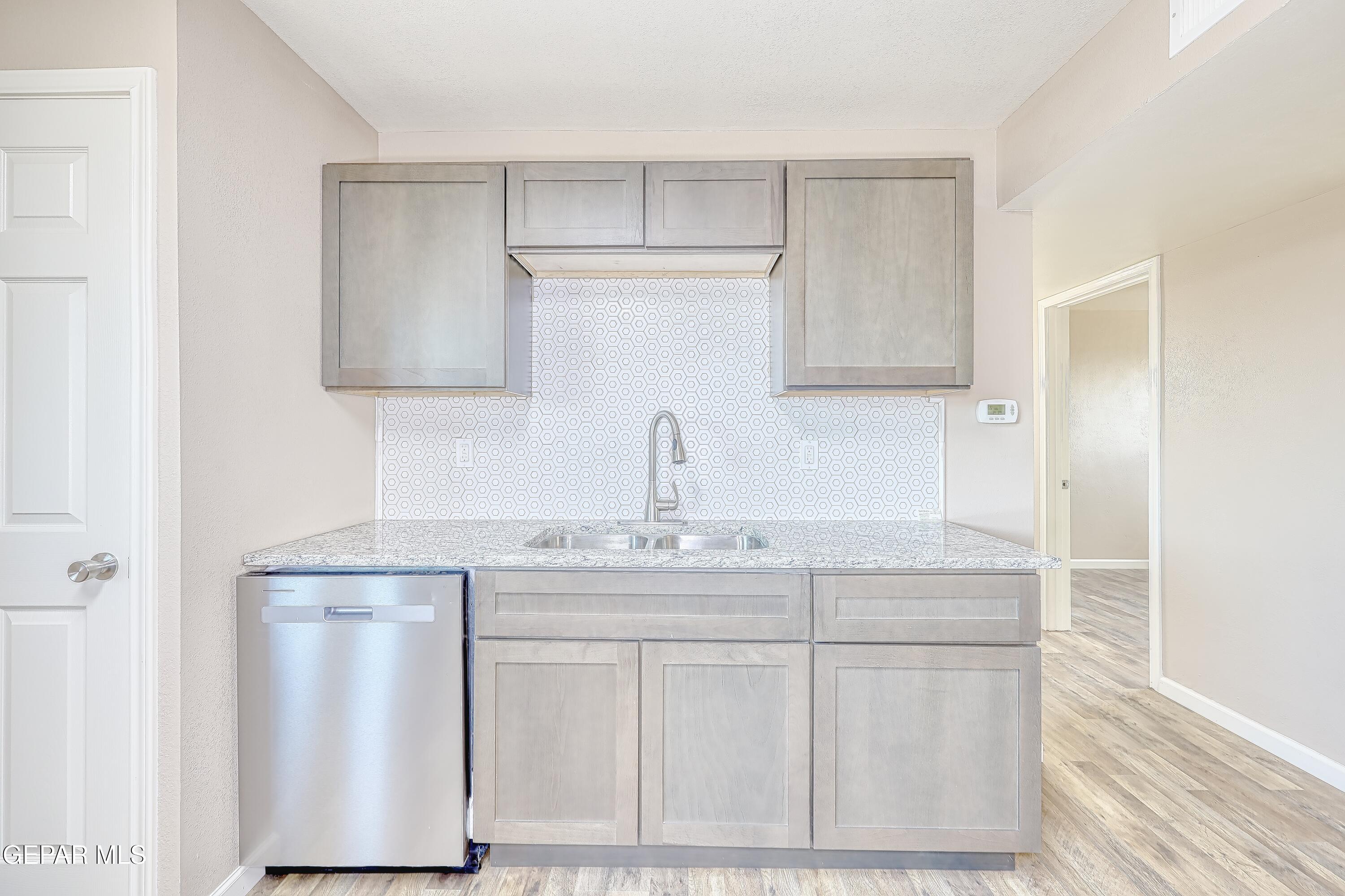 7212 Raton Drive El Paso, TX 79915 - Photo 28 of 44 a kitchen with white cabinets sink and stove