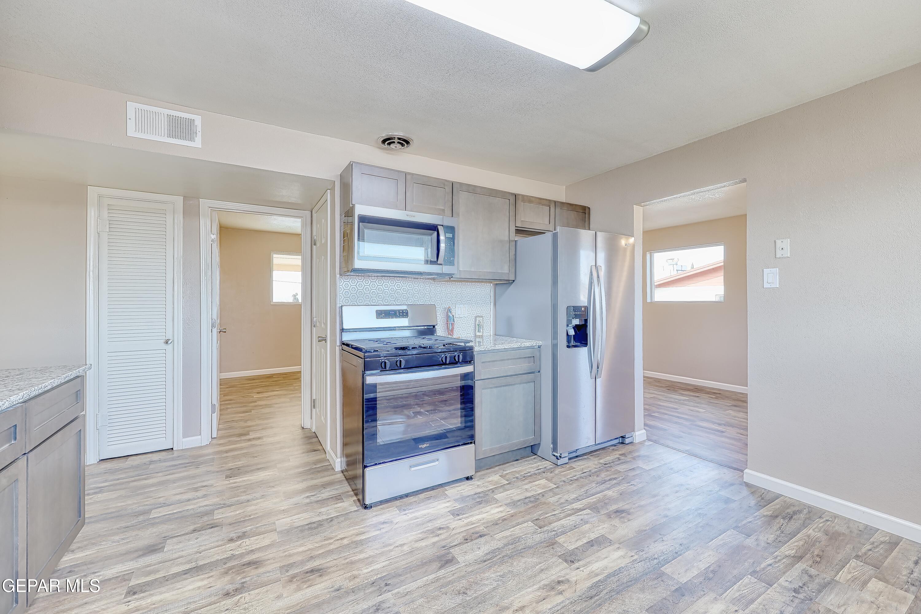 7212 Raton Drive El Paso, TX 79915 - Photo 30 of 44 a kitchen with a refrigerator and a stove top oven