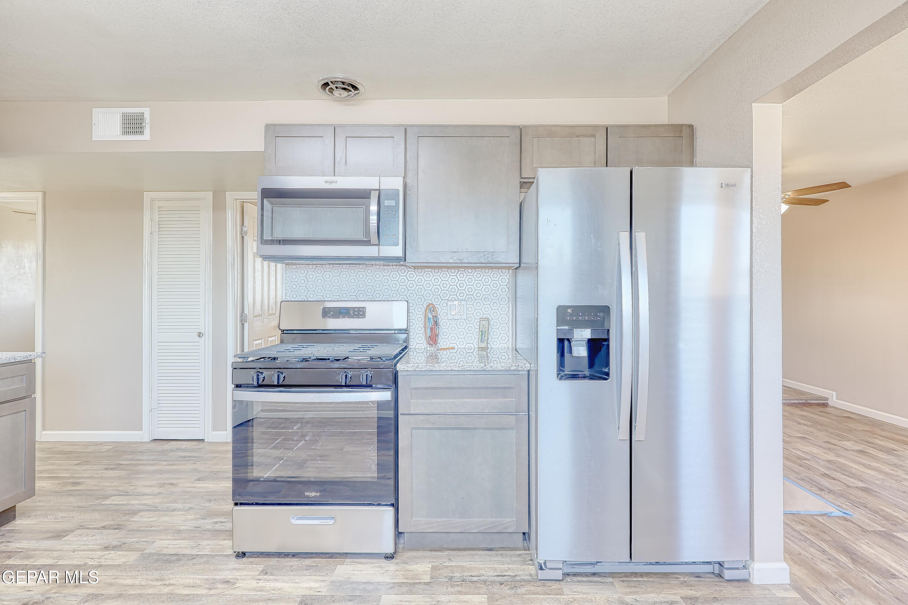 7212 Raton Drive El Paso, TX 79915 - Photo 31 of 44 a kitchen with stainless steel appliances granite countertop a refrigerator and a stove