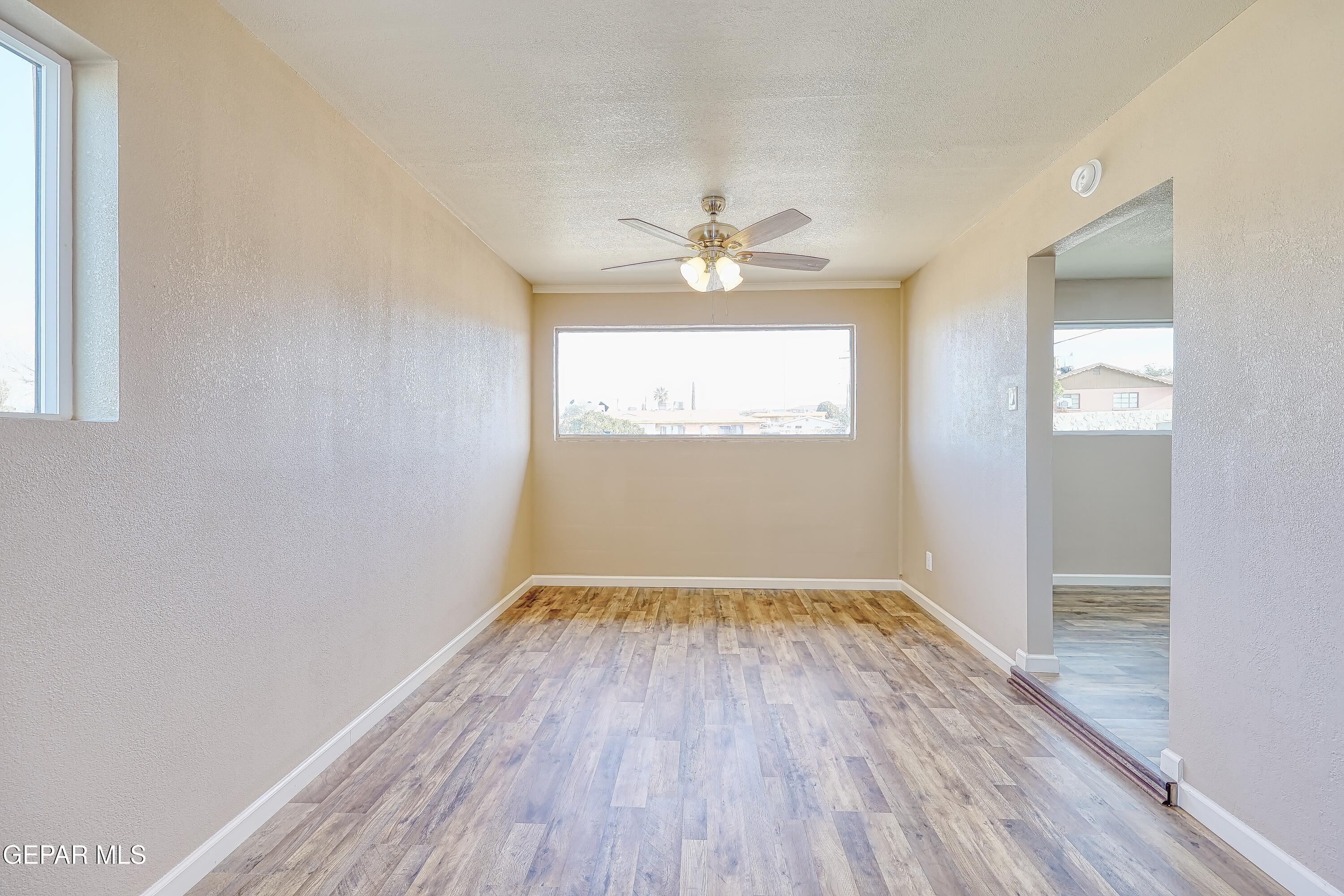 7212 Raton Drive El Paso, TX 79915 - Photo 34 of 44 an empty room with wooden floor and windows
