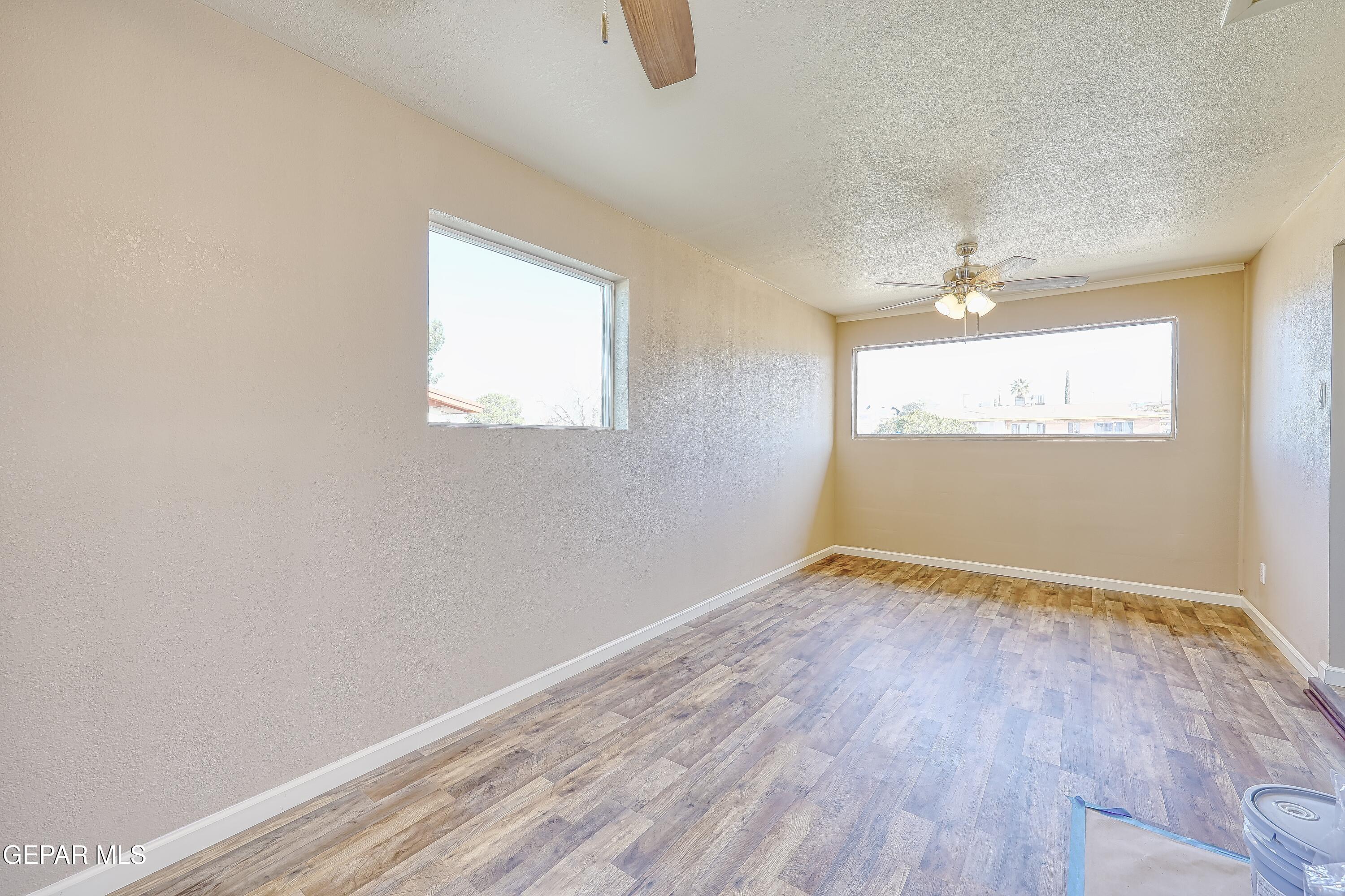 7212 Raton Drive El Paso, TX 79915 - Photo 35 of 44 an empty room with wooden floor and windows