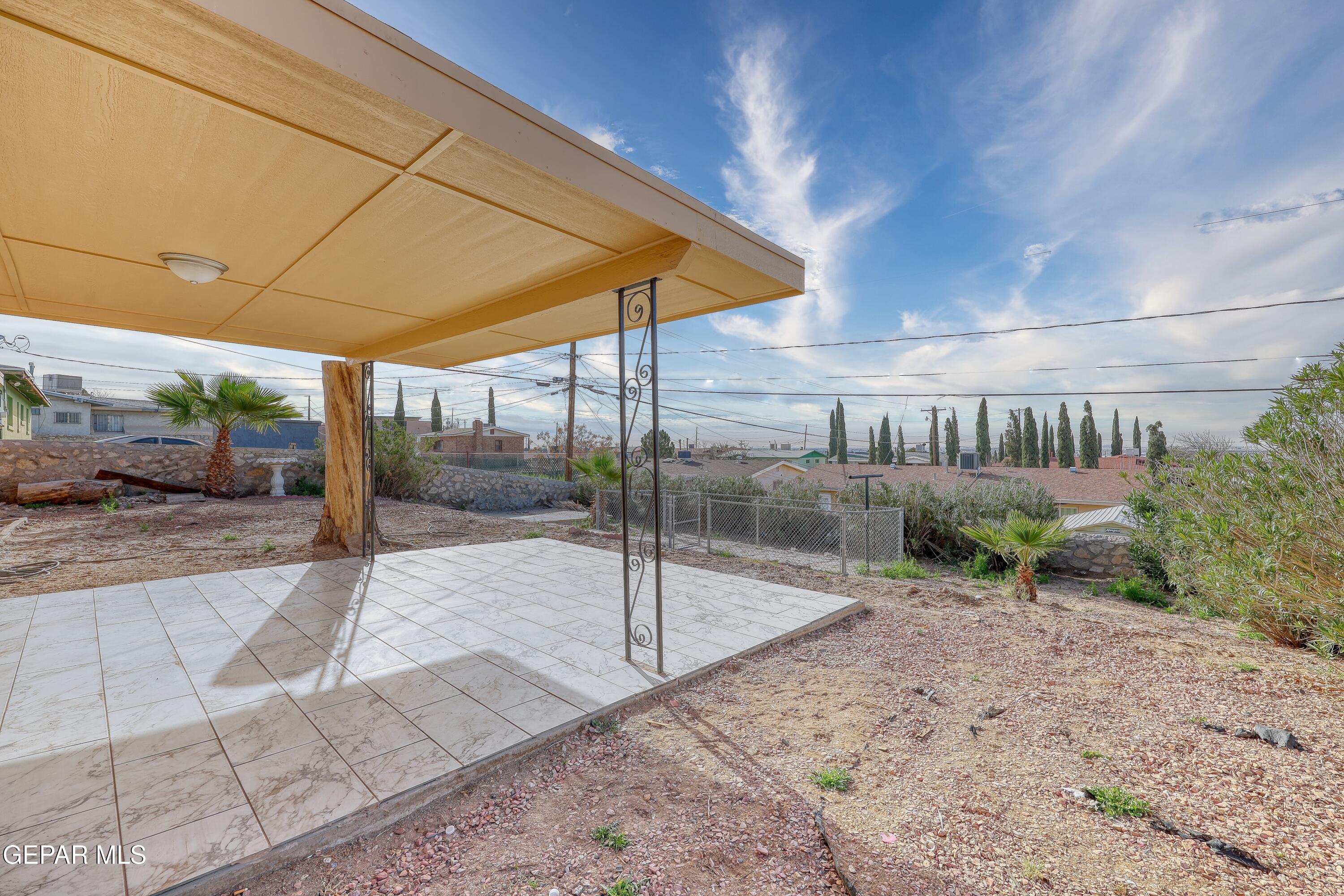7212 Raton Drive El Paso, TX 79915 - Photo 38 of 44 a view of a patio with a table and chairs under an umbrella
