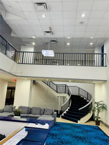 a room with lots of furniture and a chandelier