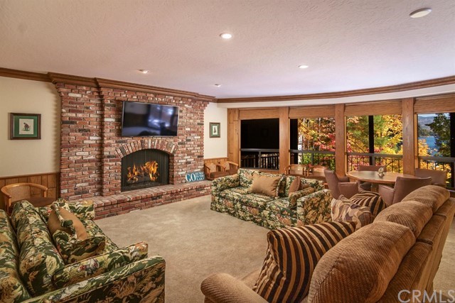 700 Oak Point Lake Arrowhead, CA 92352 - Photo 14 of 20 a living room with furniture a large window and a fireplace