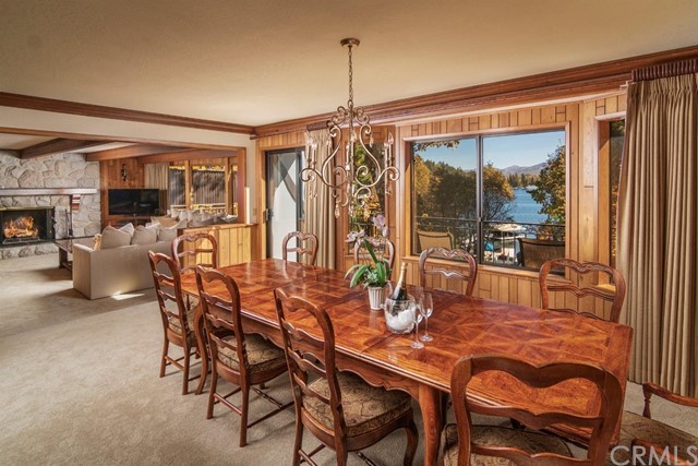 700 Oak Point Lake Arrowhead, CA 92352 - Photo 5 of 20 a dining room with furniture a chandelier and fireplace
