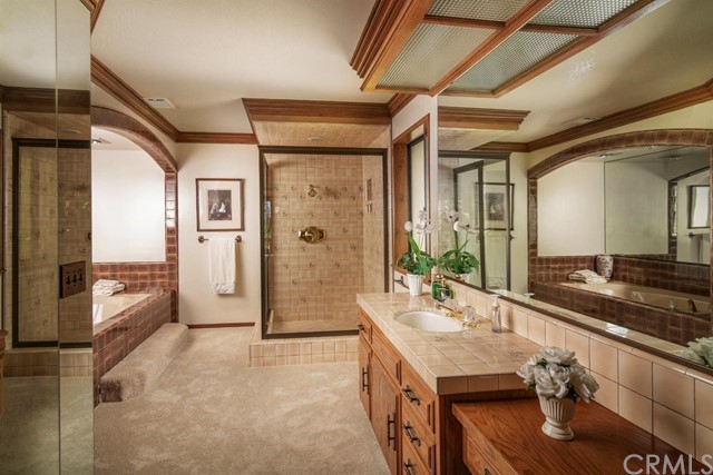 700 Oak Point Lake Arrowhead, CA 92352 - Photo 9 of 20 a bathroom with a granite countertop sink a mirror and shower