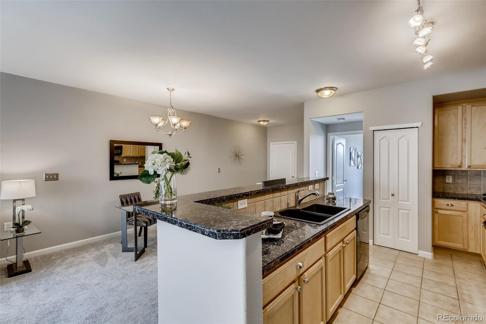 5544 Lewis Street, Unit 203 Arvada, CO 80002 - Photo 12 of 38 a kitchen that has a sink and a stove