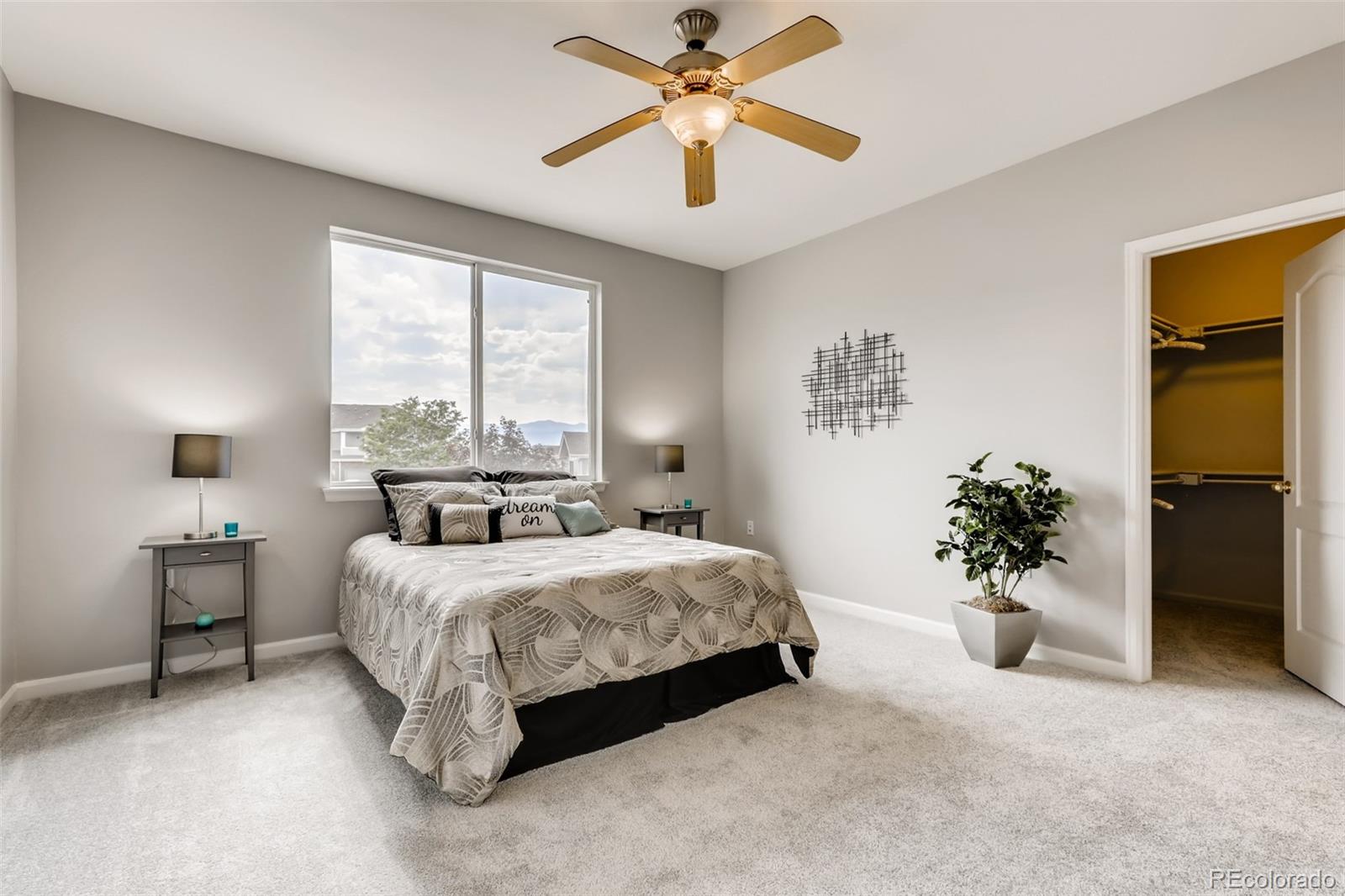 5544 Lewis Street, Unit 203 Arvada, CO 80002 - Photo 15 of 38 a bedroom with a bed and a chandelier