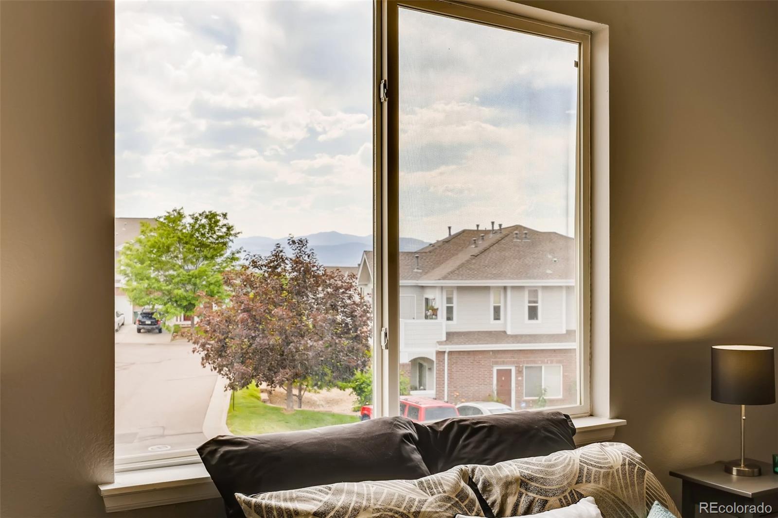 5544 Lewis Street, Unit 203 Arvada, CO 80002 - Photo 16 of 38 a living room with furniture and a floor to ceiling window