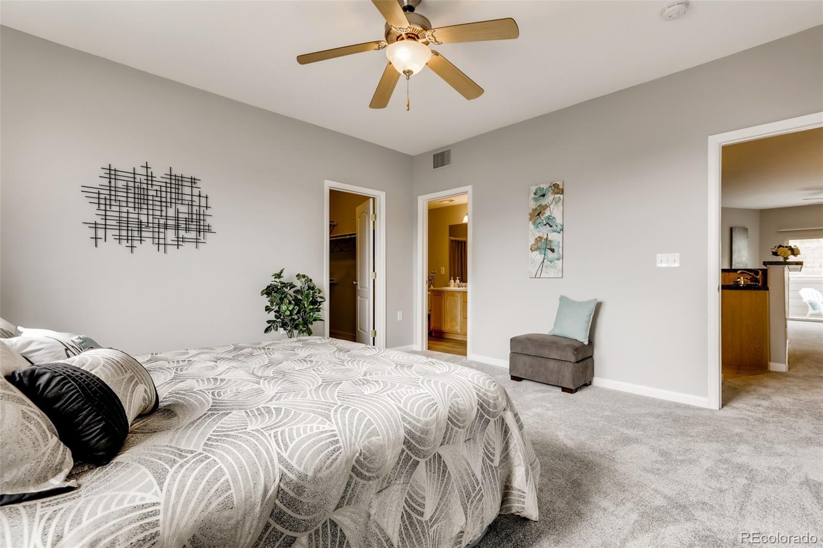 5544 Lewis Street, Unit 203 Arvada, CO 80002 - Photo 17 of 38 a bedroom with a bed and a chandelier