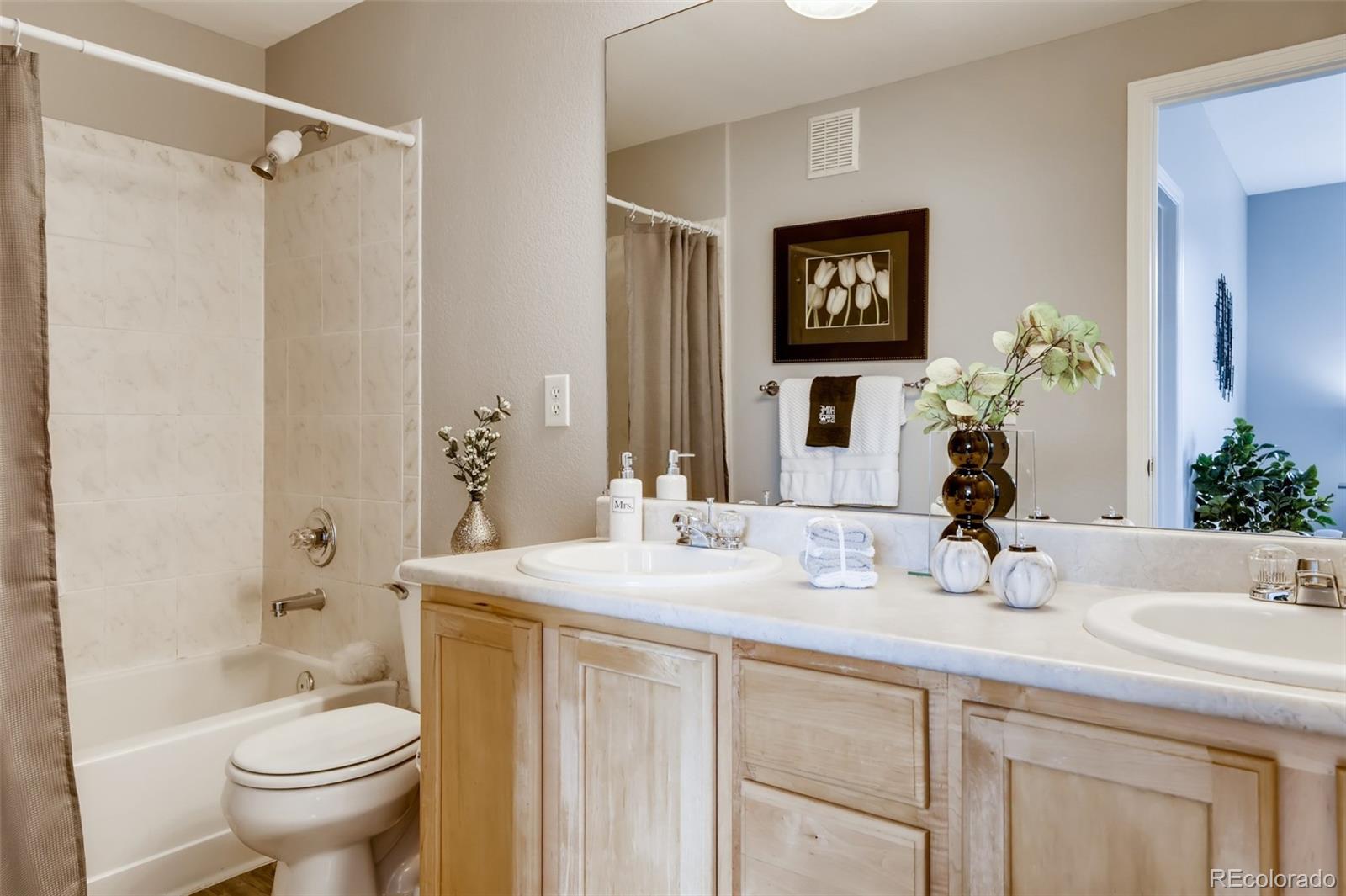 5544 Lewis Street, Unit 203 Arvada, CO 80002 - Photo 20 of 38 a bathroom with a sink a toilet and shower