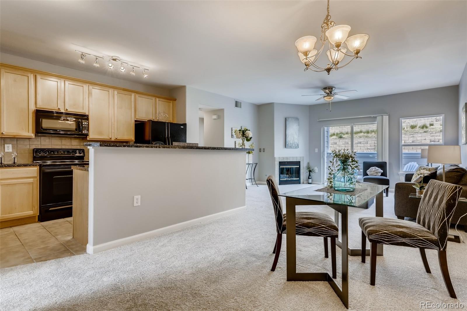 5544 Lewis Street, Unit 203 Arvada, CO 80002 - Photo 2 of 38 a view of kitchen with microwave stove top oven and cabinets
