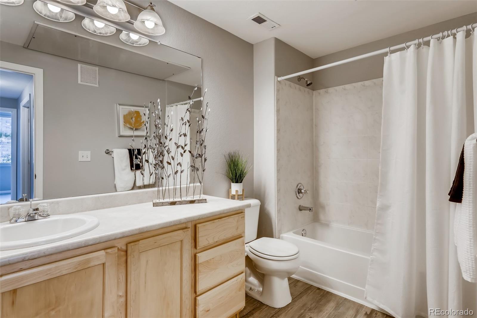 5544 Lewis Street, Unit 203 Arvada, CO 80002 - Photo 23 of 38 a bathroom with a sink a toilet and shower