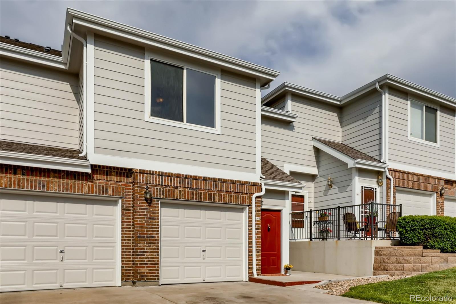 5544 Lewis Street, Unit 203 Arvada, CO 80002 - Photo 26 of 38 a front view of a house with a garage