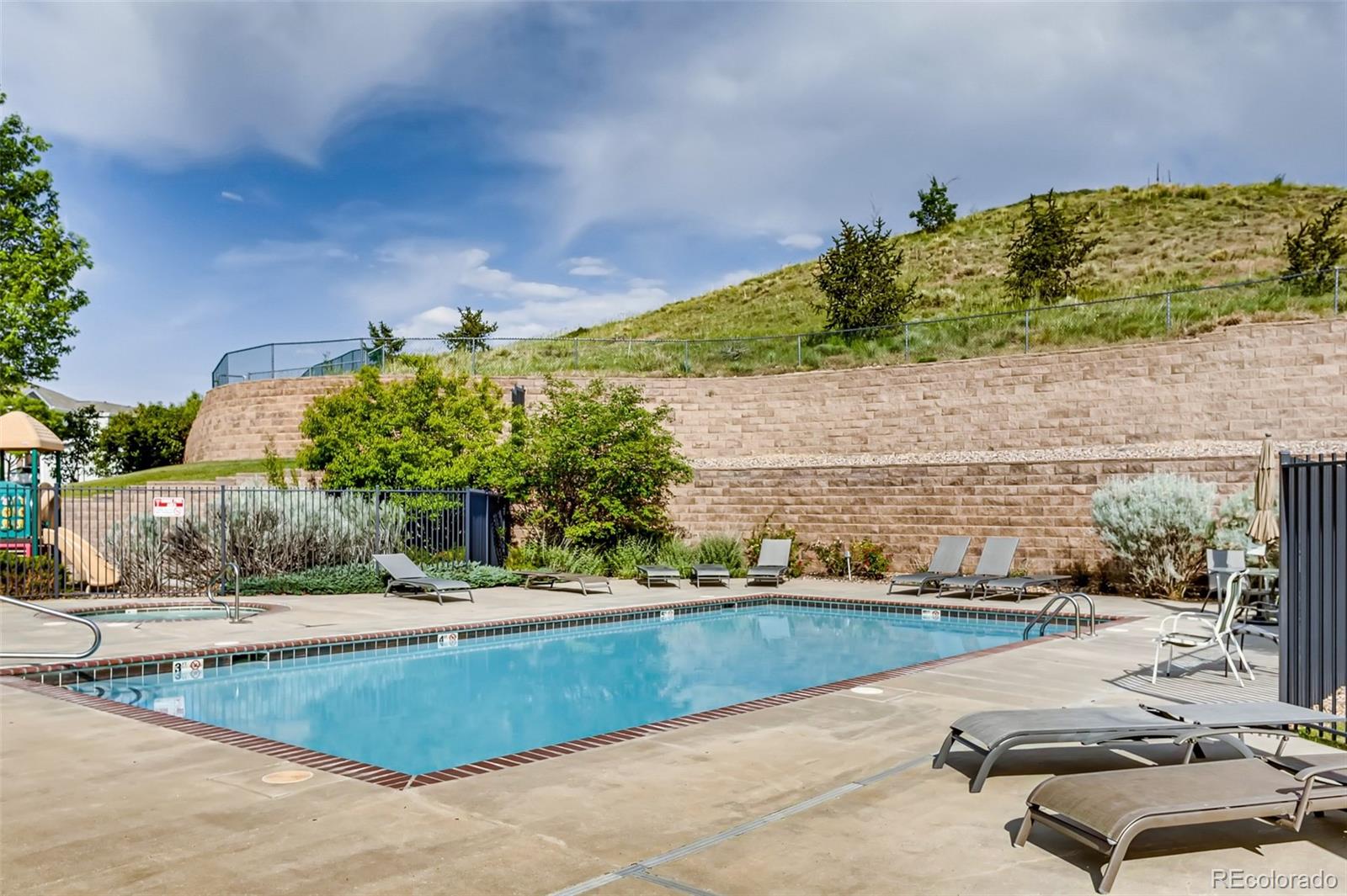 5544 Lewis Street, Unit 203 Arvada, CO 80002 - Photo 28 of 38 a view of a swimming pool with a yard