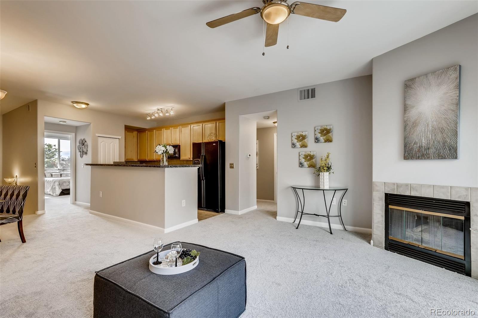 5544 Lewis Street, Unit 203 Arvada, CO 80002 - Photo 3 of 38 a living room with furniture and a kitchen