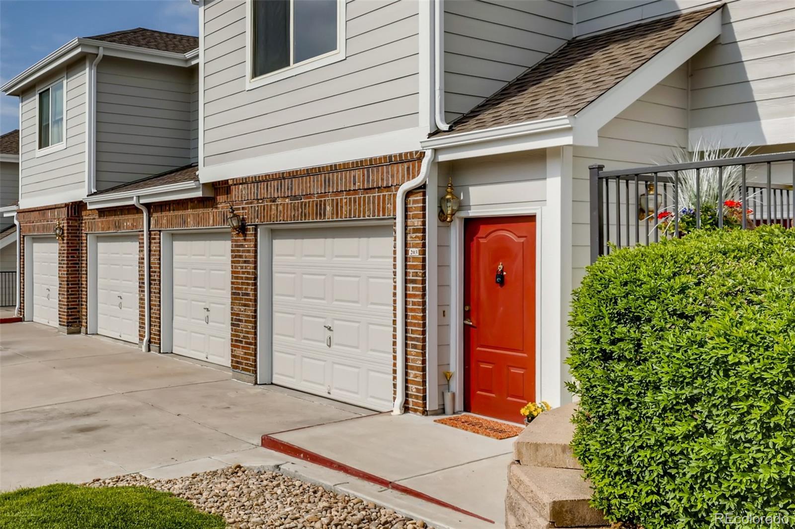 5544 Lewis Street, Unit 203 Arvada, CO 80002 - Photo 4 of 38 a front view of a house with a garage