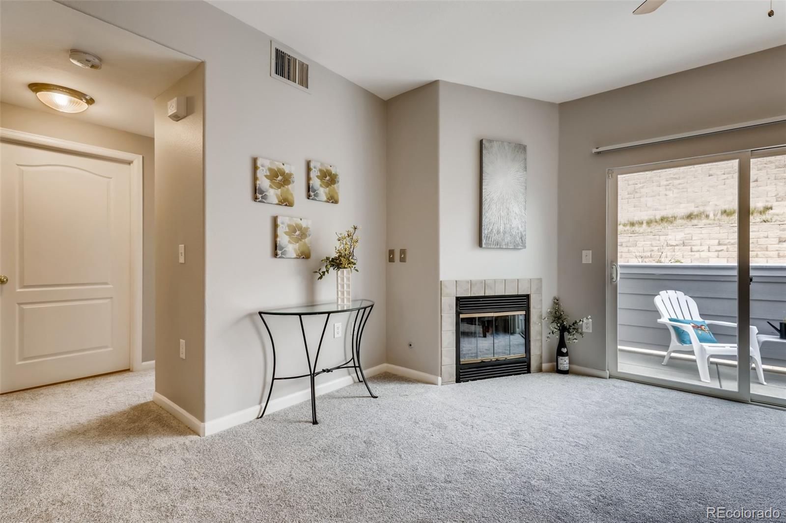 5544 Lewis Street, Unit 203 Arvada, CO 80002 - Photo 6 of 38 a view of a livingroom with furniture and a fireplace