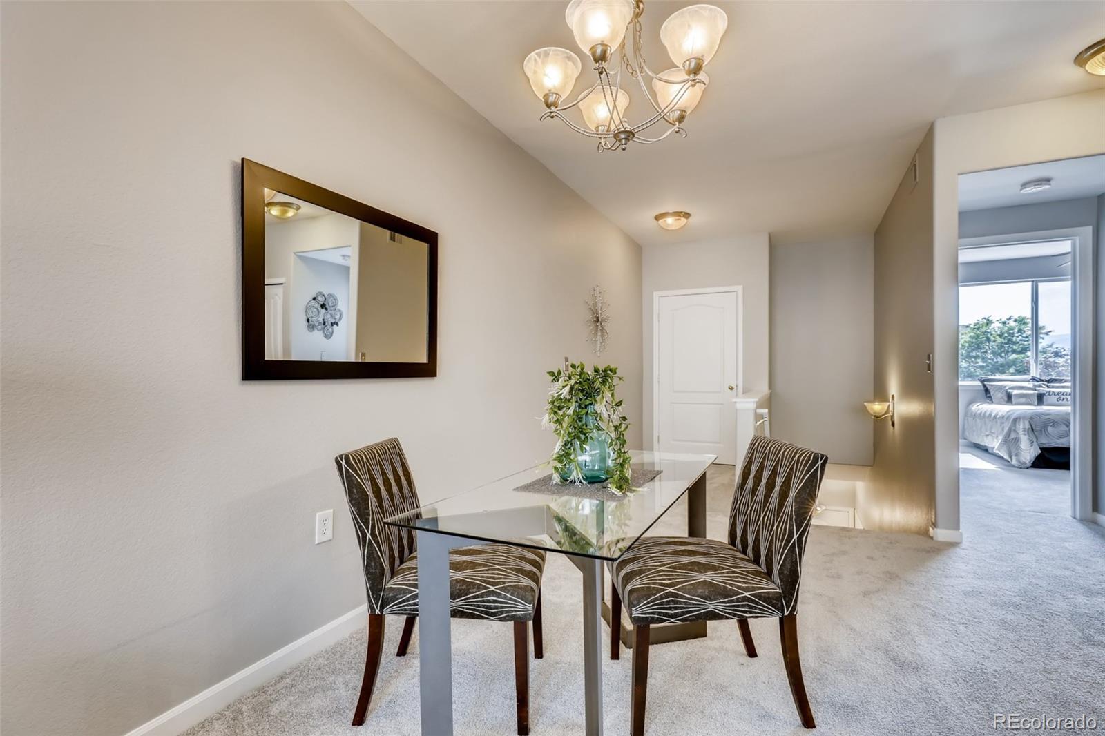 5544 Lewis Street, Unit 203 Arvada, CO 80002 - Photo 7 of 38 a view of a dining room with furniture and chandelier