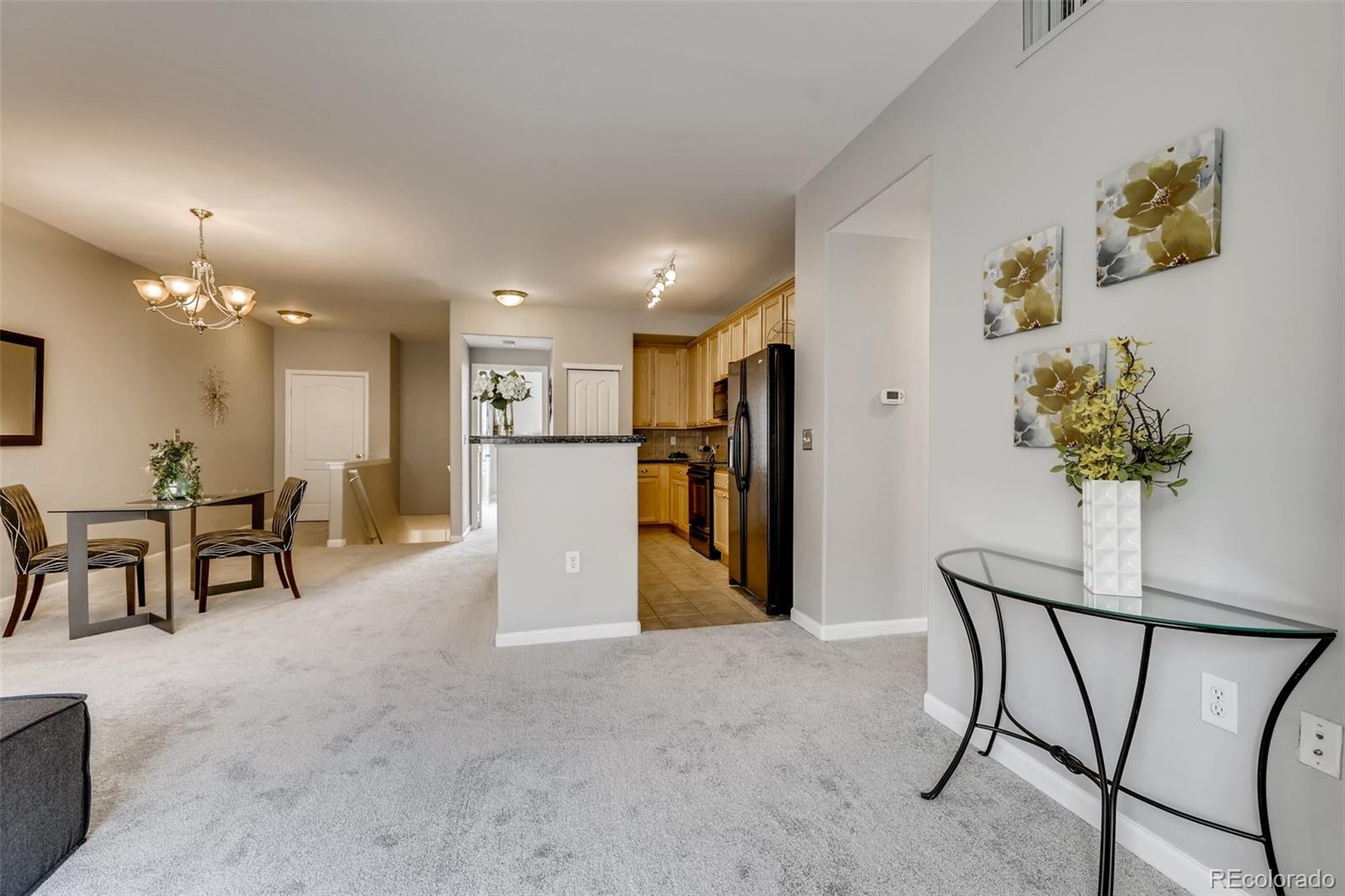 5544 Lewis Street, Unit 203 Arvada, CO 80002 - Photo 9 of 38 a view of a hallway with furniture and a potted plant