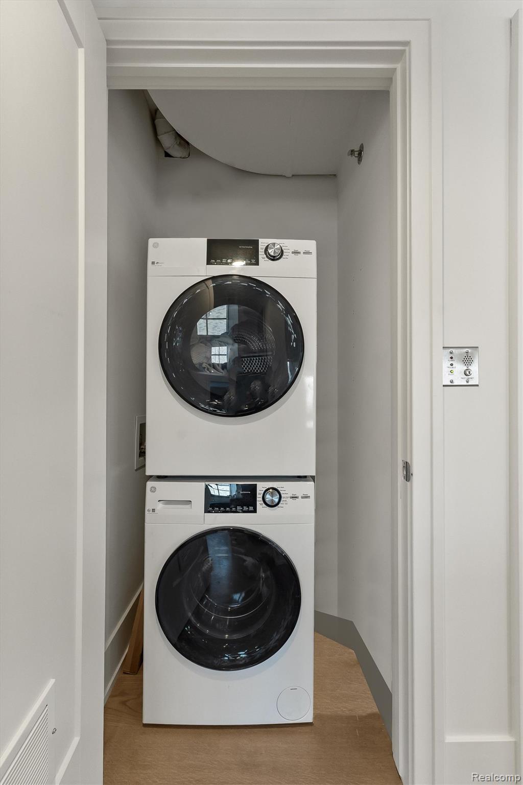 936 West Eleven Mile Road Royal Oak, MI 48067 - Photo 14 of 19 Laundry area featuring stacked washer / drying machine and light wood-style flooring