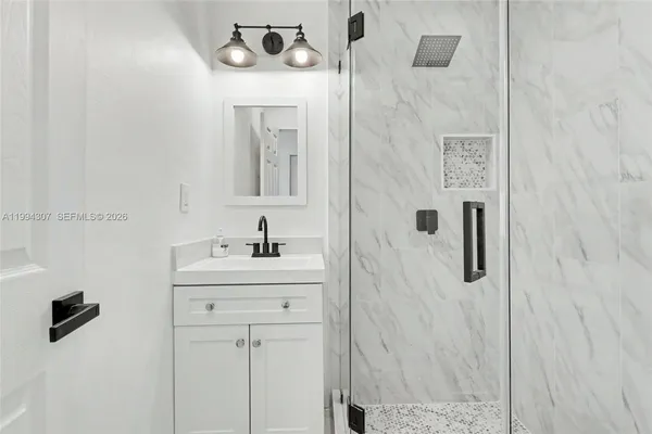 a bathroom with a sink vanity and a mirror