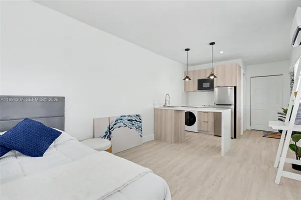 a bedroom with a bed and white cabinets