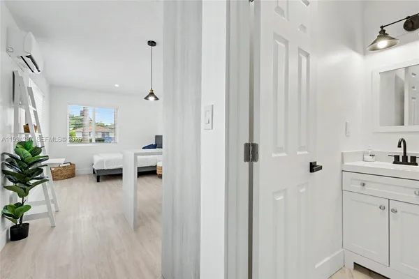 a living room with furniture and entryway