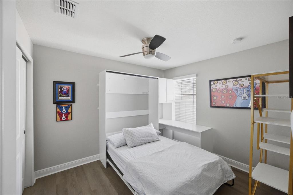 2013 Sunset Wind Loop Oldsmar, FL 34677 - Photo 24 of 43 a bedroom with a bed and a table in it